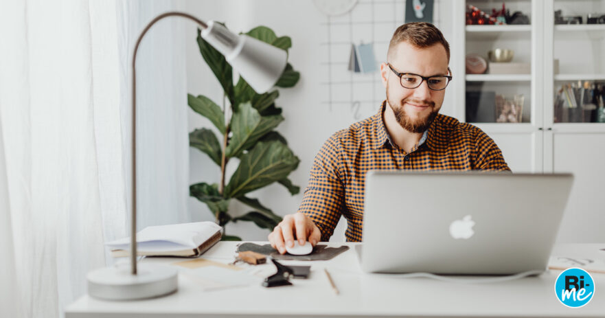 Man sitting at desk with laptop explaining Bi-me and business insurance